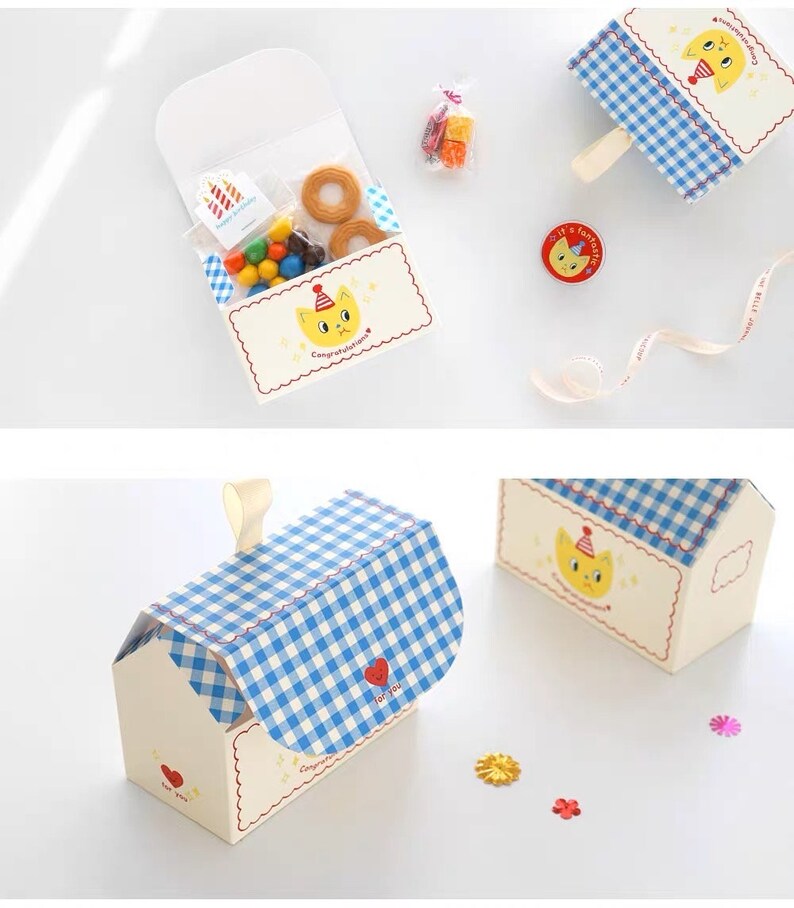 May include: A set of three white and blue gingham gift boxes with a cat design. The boxes are decorated with a red heart and the text "Congratulations" and "I love you".