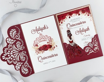 May include: Burgundy red laser cut invitation with a white background. The invitation features a crown with red roses and gold accents. The text reads "Aaliyah's Quinceañera April 17th, 2025".