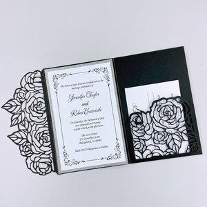 May include: Black and silver wedding invitation with a laser cut floral design. The invitation reads "The honor of your presence is requested at the marriage celebration of Jennifer Taylor and Robert Entwistlo. On Saturday, the thirteenth of July two thousand and twenty at four o'clock in the afternoon. The Levy Center 251 Canterbury Lane Belingbrook, IL 60440 Adult ONLY Reception to Follow."