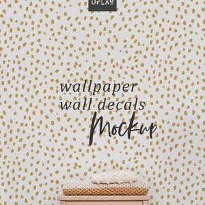 May include: A white wall with a gold polka dot pattern. A wooden stool with a white knitted blanket on top. The text "wallpaper wall decals Mockup" is written on the wall.