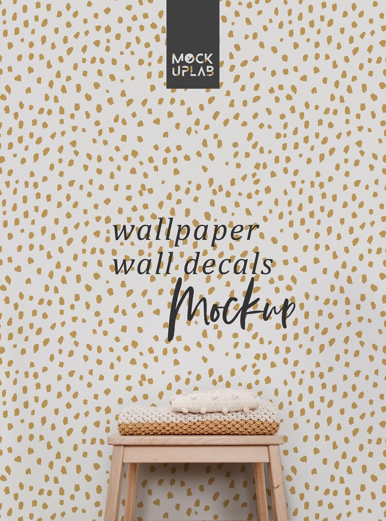 May include: A white wall with a gold polka dot pattern. A wooden stool with a white knitted blanket on top. The text "wallpaper wall decals Mockup" is written on the wall.