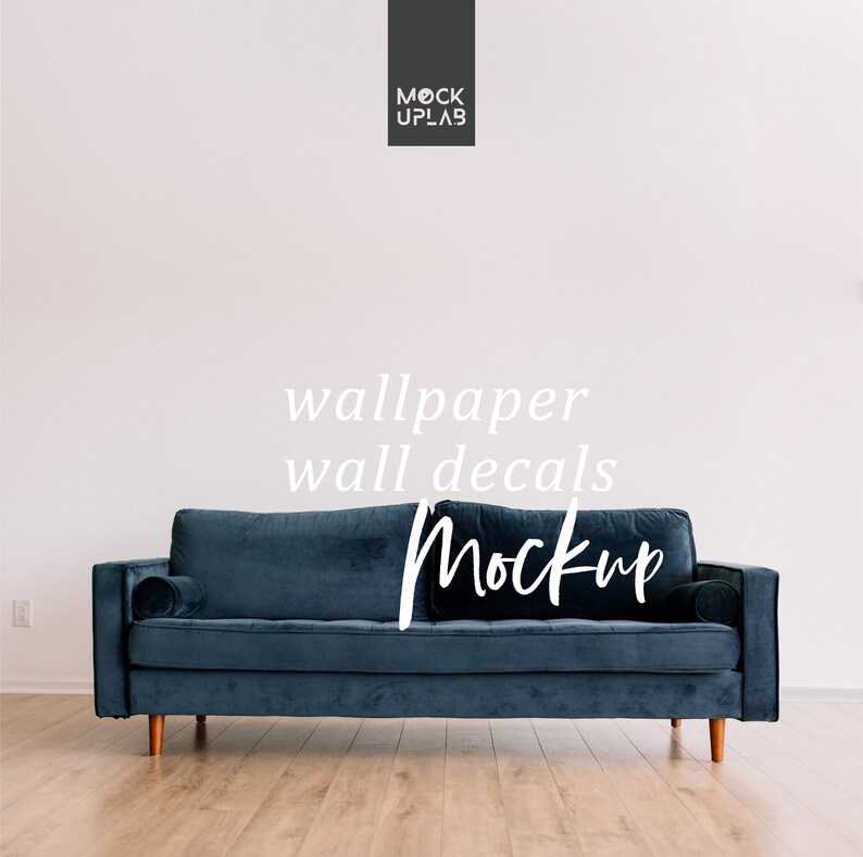 May include: A dark blue velvet sofa with wooden legs sits in front of a white wall. The text "wallpaper wall decals Mockup" is written in white on the wall.
