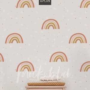 May include: A white wall with a terrazzo pattern featuring a repeating rainbow design. A small wooden stool with a knitted blanket on top sits in front of the wall.