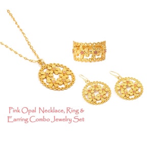 May include: A gold-coloured jewellery set comprising a necklace, ring, and earrings. Each item features a floral pattern with pink opal details. The set includes a pendant necklace, a ring, and drop earrings. The text reads: Pink Opal Necklace, Ring & Earring Combo Jewelry Set.