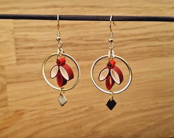 Golden dangling earrings in red paper