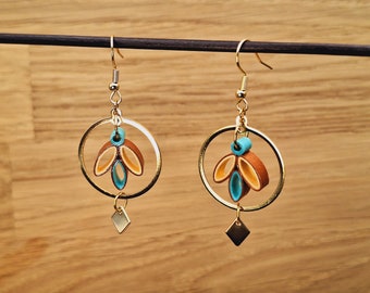 Gold dangling earrings in brown, gold and turquoise paper