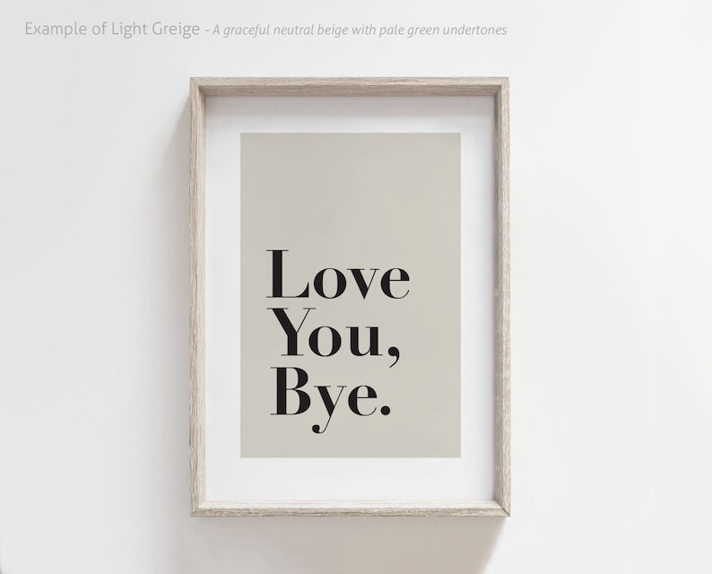 May include: A framed print with a light beige background and black text that reads "Love You, Bye."