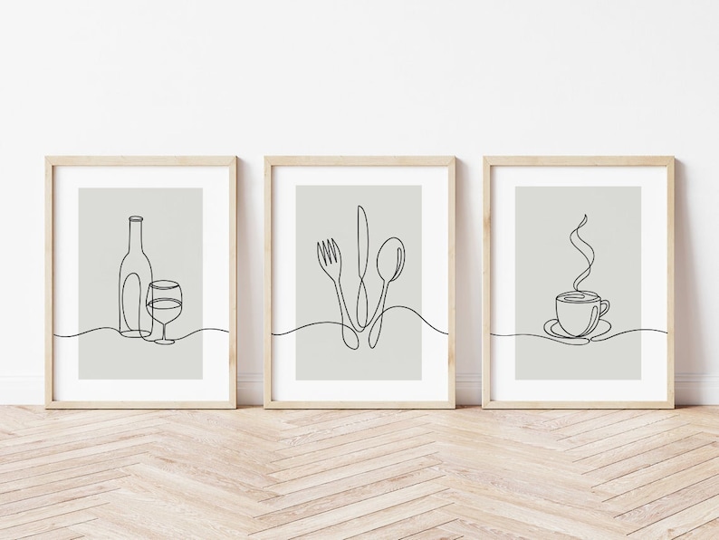 May include: Three minimalist line art prints in wooden frames. The prints depict a wine bottle and glass, a fork, knife, and spoon, and a steaming cup of coffee.