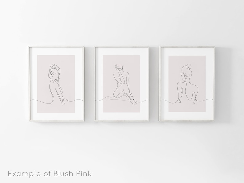 May include: Three framed prints with a blush pink background and black line drawings of women in various poses.