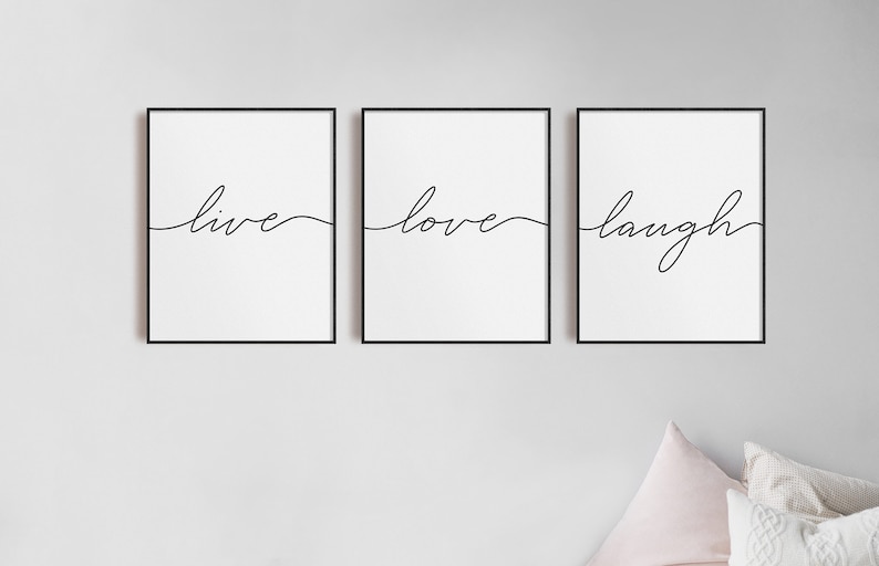 May include: Three black framed prints with white backgrounds and black cursive text. The prints read "live", "love", and "laugh".