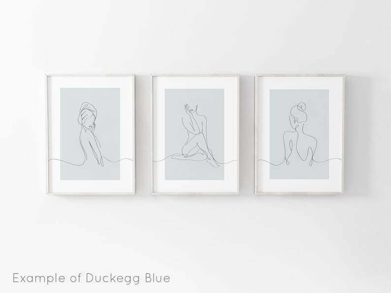 May include: Three framed prints with a light blue background and black line drawings of women in various poses. The prints are arranged in a row.