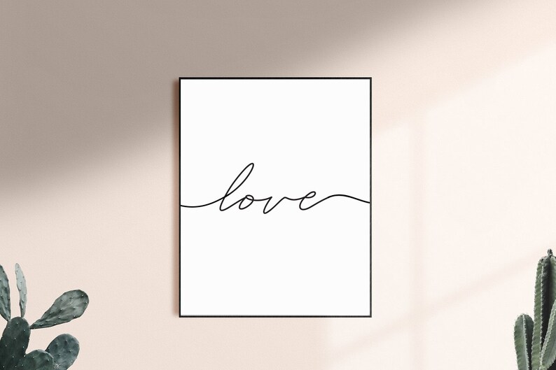 May include: A black and white minimalist print with the word "love" written in a single continuous line.