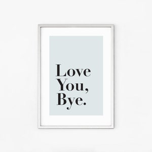 May include: A framed print with a light blue background and the text "Love You, Bye." in black.