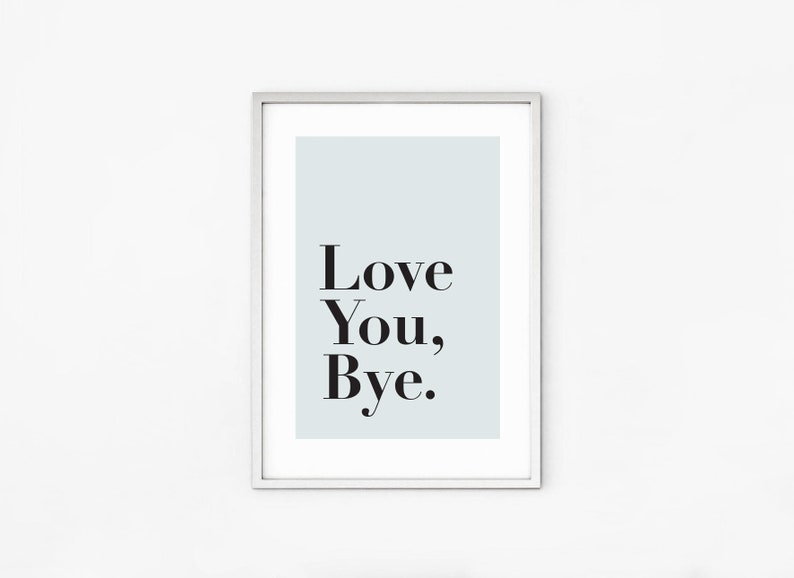 May include: A framed print with a light blue background and the text "Love You, Bye." in black.