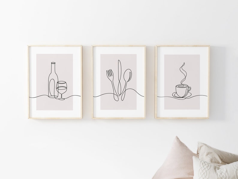 May include: Three minimalist line art prints in wooden frames. The prints depict a wine bottle and glass, a fork, knife, and spoon, and a steaming cup of coffee.