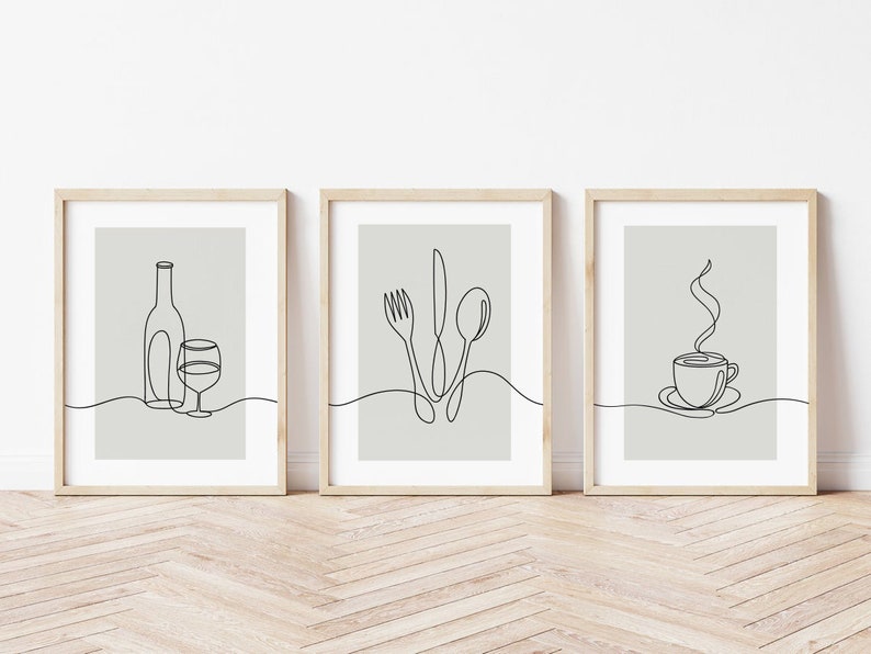 May include: Three minimalist line art prints in wooden frames. The prints depict a wine bottle and glass, a fork, knife, and spoon, and a steaming cup of coffee.