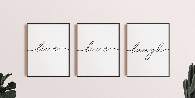 May include: Three black framed prints with white backgrounds and black cursive text. The prints read "live", "love", and "laugh".