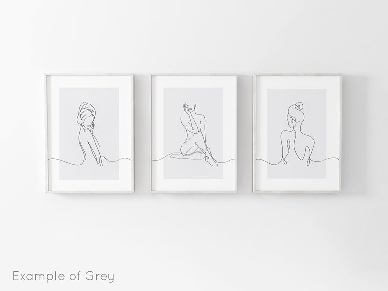 May include: Three minimalist line art prints featuring a single line drawing of a woman in different poses. The prints are framed in white and have a light gray background.