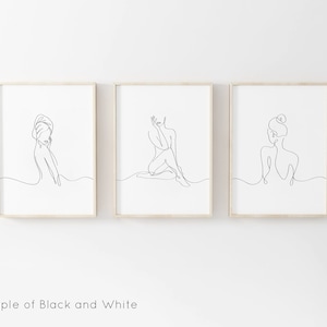 May include: Three black and white line drawings of women in various poses. The drawings are framed in simple wooden frames and are hung on a white wall.