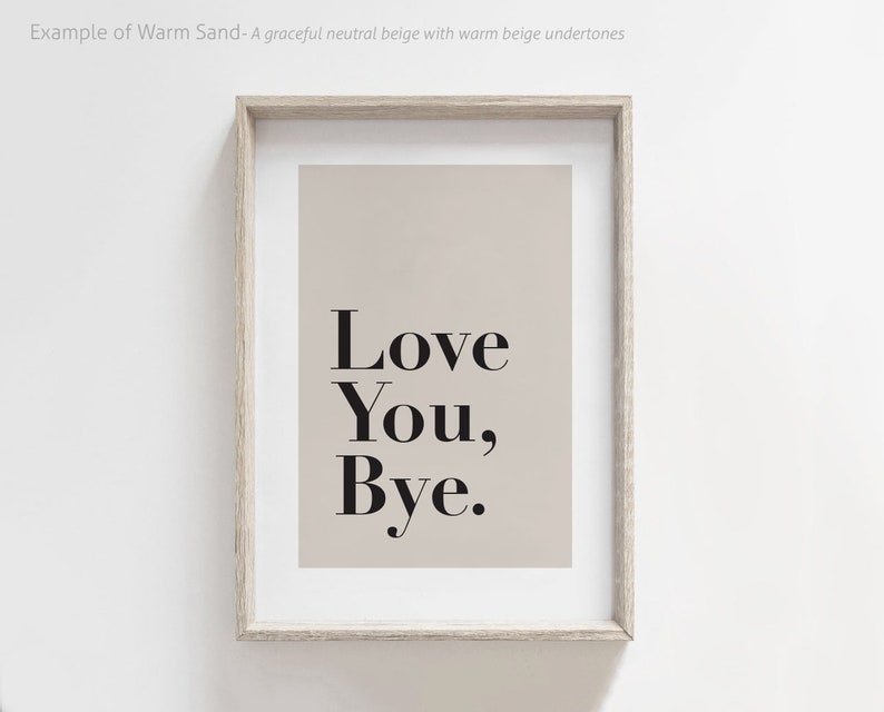 May include: A framed print with a beige background and black text that reads "Love You, Bye."