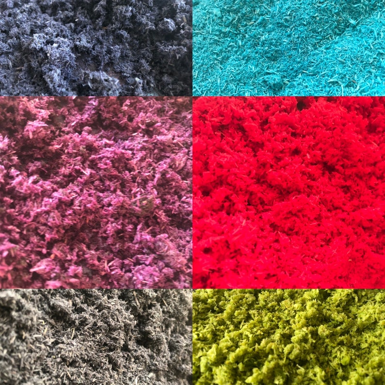 May include: A collage of five different coloured shredded paper or moss. The colours are black, blue, purple, red, and green.