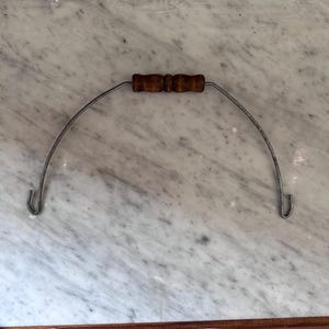 May include: A white ceramic mug with a black handle and the text "But First, Coffee" in a bold, black font. The mug is set against a blurred background, suggesting a cozy setting. The mug appears to be approximately 4 inches tall.