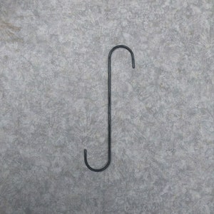 May include: A black metal S-shaped hook.