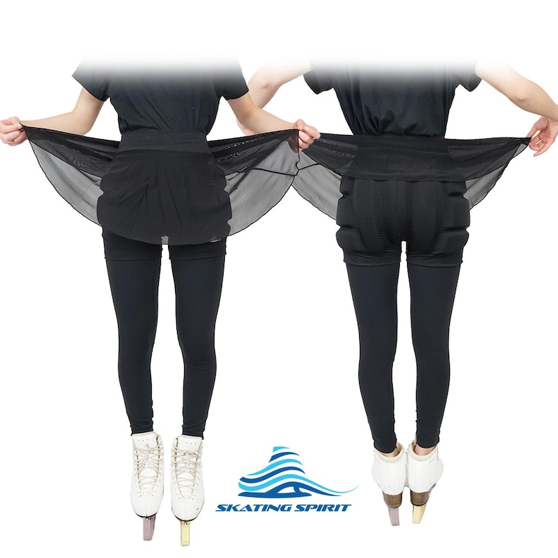 May include: Black figure skating skirt with a sheer overlay. The skirt is worn over black leggings and the model is wearing black ice skates.