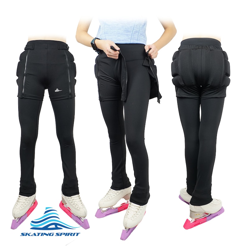 May include: Black figure skating trousers with built-in padding for the hips and tailbone. The trousers are worn by a person standing on ice skates. The text "SKATING SPIRIT" is visible at the bottom of the image.