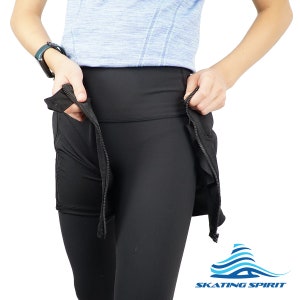 May include: Black leggings with a black skirt overlay that has two zipped pockets on the sides. The skirt can be pulled up to reveal the leggings. The leggings and skirt are made of a stretchy, comfortable fabric. The brand name "SKATING SPIRIT" is visible in the bottom right corner of the image.