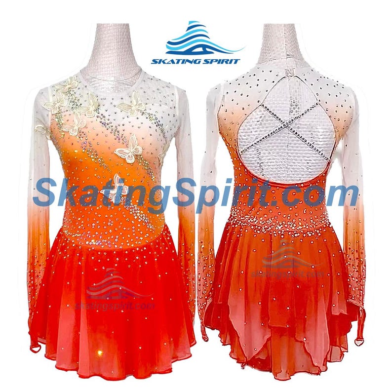 May include: Orange and white figure skating dress with long sleeves, a white bodice with butterfly embellishments, and a layered skirt. The back of the dress features a criss-cross design with rhinestones.
