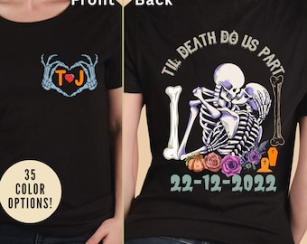 May include: Black t-shirt with a skeleton couple graphic on the back. The graphic says "Til Death Do Us Part" and includes a heart, flowers, and a date. The front of the shirt has a skeleton hand heart graphic with the initials "TJ".