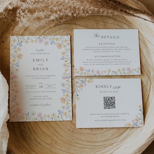 May include: A wedding invitation suite featuring a main card, a details card, and an RSVP card with a QR code. Each white card is decorated with a delicate floral border in shades of yellow, pink, and blue. The text includes names Emily and Brian.