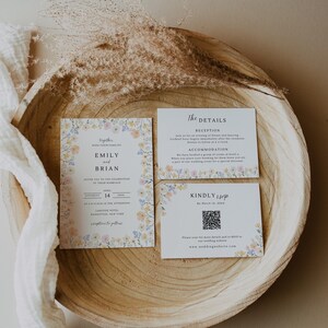 May include: Wedding invitation suite featuring floral designs in pastel colors. The suite includes an invitation, details card, and RSVP card. The invitation includes the names Emily and Brian, the date, and location. The RSVP card has a QR code.