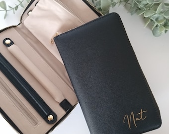 May include: Black zippered jewelry case with a gold zipper and a beige interior. The case is open and the interior is visible. The case has a gold zipper pull with a small metal charm. The case is personalized with the name "Nat" in gold lettering.