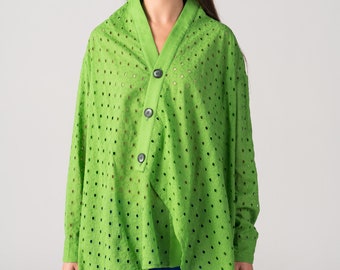 May include: A lime green, long-sleeved, button-up shirt with a  pattern of small, evenly spaced holes. The shirt has a V-neck and a slightly asymmetrical hemline.