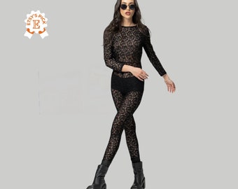 May include: Black lace bodysuit with long sleeves and a high neckline. The bodysuit has a floral pattern and is worn with black boots.