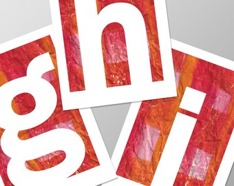 May include: White letters 'g', 'h', and 'i' cut out of paper with a red and orange patterned background.