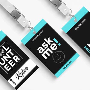 May include: Three volunteer ID badges with white lanyards. The badges have a black background with white and light blue accents. Text on the badges includes "VOLUNTEER", "ask me!", and "how can I serve". One badge has the name "Kylee".