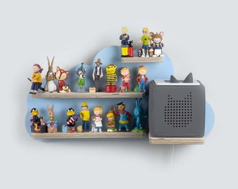 May include: A blue cloud-shaped shelf with two wooden shelves, displaying a collection of colorful figurines. A gray speaker with ear-like protrusions is attached to the shelf. The figurines include animals and people.