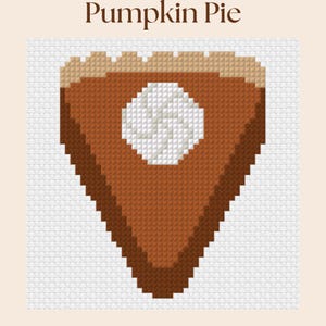 May include: A cross-stitch pattern of a triangular slice of pumpkin pie with a tan crust, a brown filling, and a white dollop of whipped cream in the centre. The text Pumpkin Pie is printed in brown above the pie graphic on a white grid background.