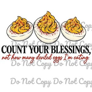 May include: Three deviled eggs with yellow yolks and red paprika seasoning, positioned above the black and red text: COUNT YOUR BLESSINGS, not how many deviled eggs I'm eating. The design features a white background and a watermark.
