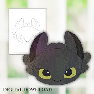 May include: A black and gray cartoon illustration of a dragon's head with yellow eyes. A line drawing of the same dragon head is on a white sheet of paper. The words "DIGITAL DOWNLOAD" are at the bottom.