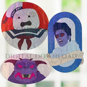 May include: Three stained glass patterns featuring a Stay Puft marshmallow character, a purple horned creature, and a figure with red eyes in a blue frame with a banner that reads Are You A God? The designs are presented as digital downloads.