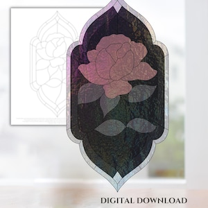 Puede incluir: Un patrón de vitral de una rosa rosa con hojas verdes en un marco negro. El patrón está en un estilo de vitral tradicional con un diseño geométrico.