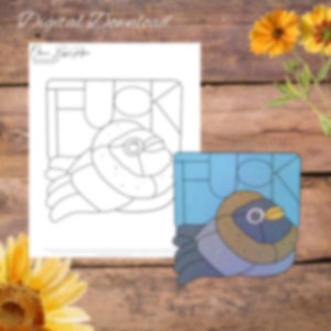 May include: A printable coloring page featuring a stylized bird with the word "F**K" spelled out in a stained glass style. The bird is in a blue and brown color scheme.