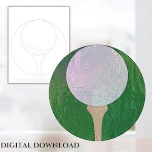 May include: A stained glass design of a golf ball on a tee. The golf ball is white with blue dimples and the tee is brown. The background is green.