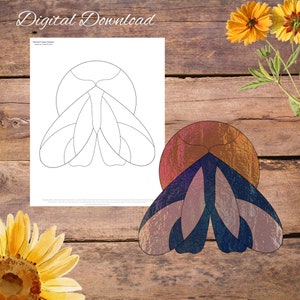 May include: A stained glass pattern design of a butterfly with a black outline. The pattern is shown on a white sheet of paper. A completed stained glass butterfly is shown on a wooden surface. The butterfly is made of iridescent glass with shades of blue, purple, and brown.