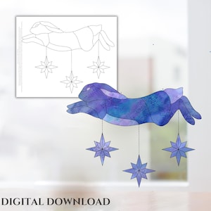 May include: A stained glass pattern of a blue rabbit with stars hanging from its paws. The rabbit is in a leaping pose. The stars are five-pointed and have a blue and purple color scheme.