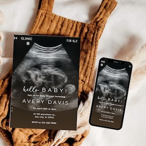 May include: A baby shower invitation and a smartphone displaying the same design. The invitation features a sonogram image with the text "hello BABY!" and event details. The phone shows the same design.